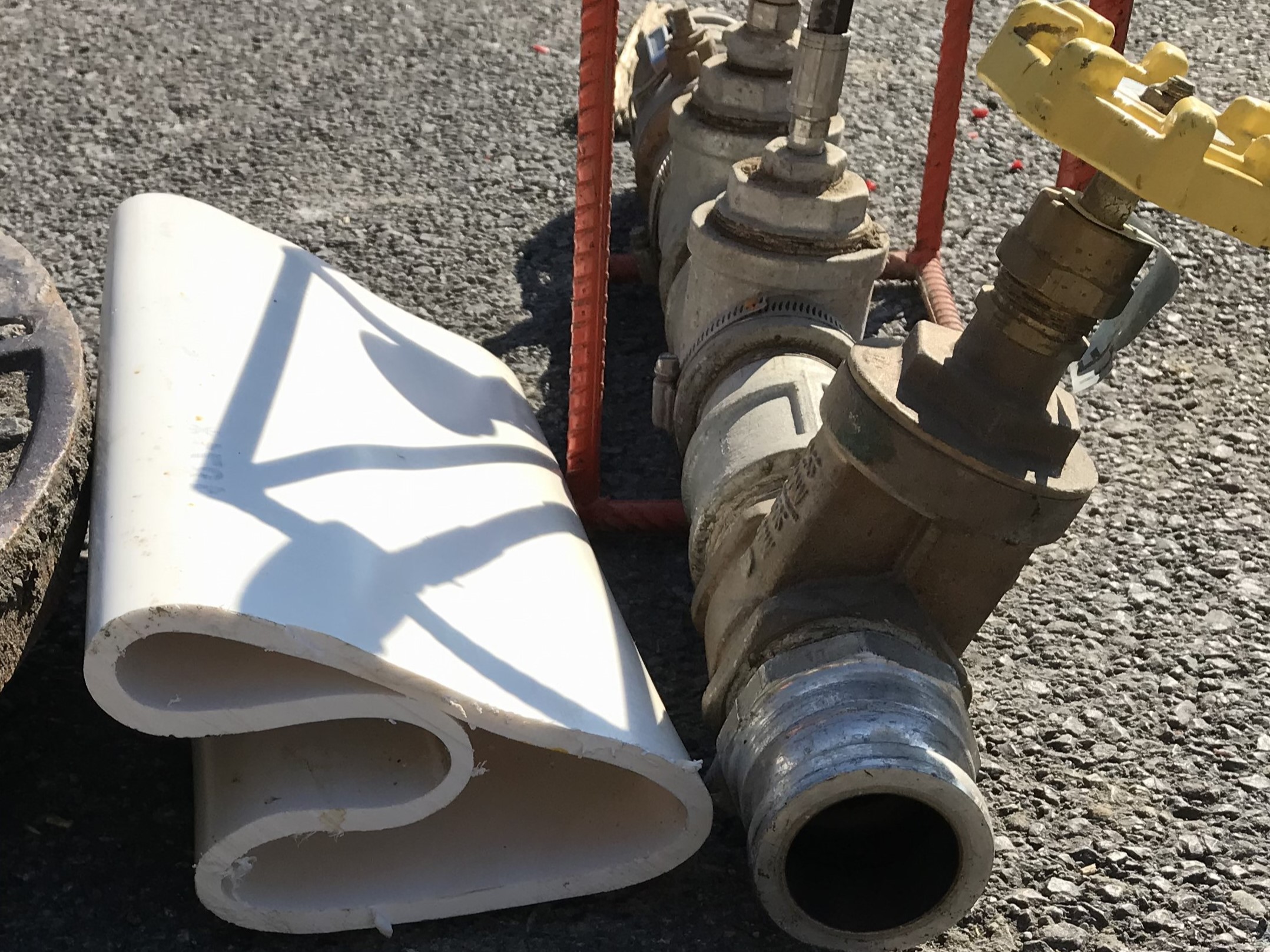 An image of a piece of the special white PVC liner lying on the ground next to a steam valve with a yellow knob on top